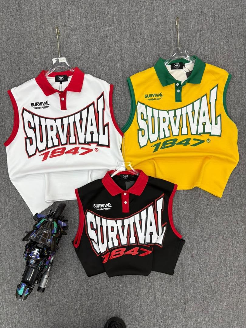 White, yellow, and black Survival 1847 sleeveless polos displayed together on hangers.