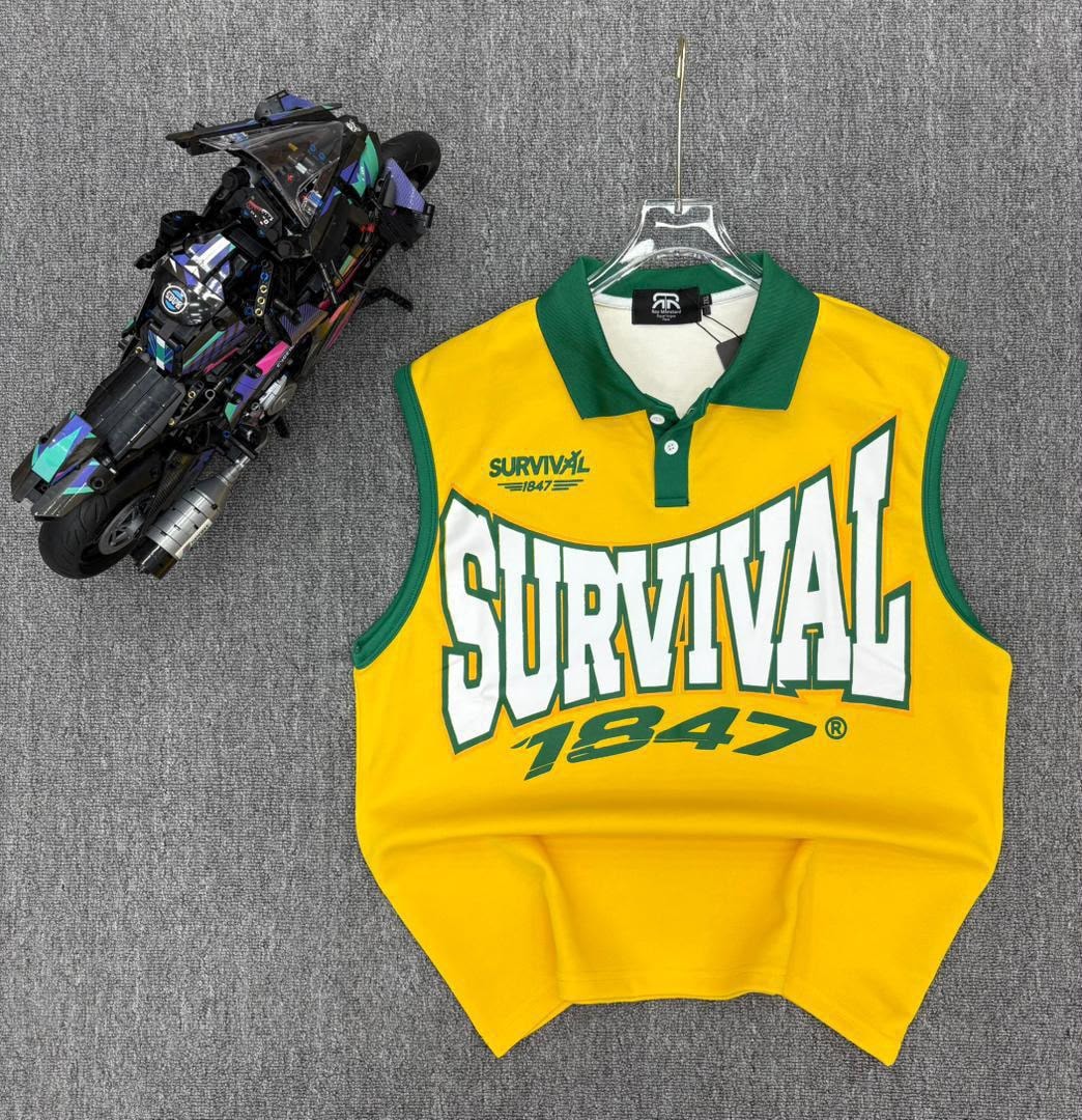 Yellow sleeveless polo shirt with green trim and SURVIVAL 1847 graphic on hanger next to toy motorcycle.