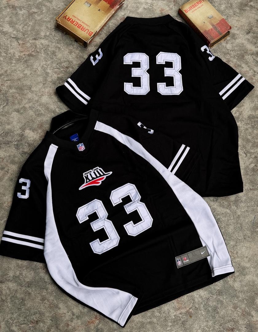 Two number 33 mesh jerseys in black and white with graphic prints on chest.