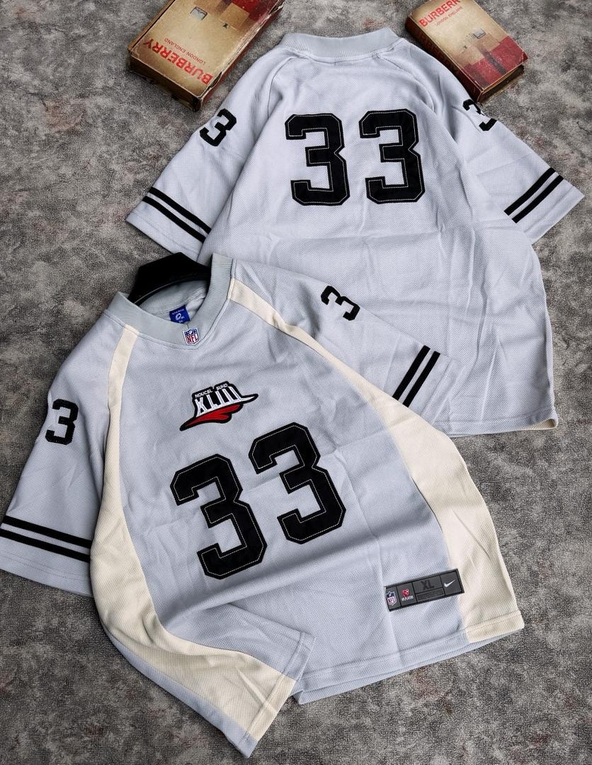 Two number 33 mesh jerseys in gray and cream colorways laid flat.