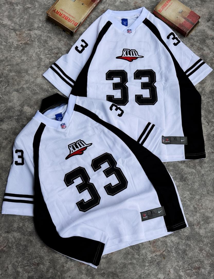 Two number 33 mesh jerseys in white and black colorways with graphic details.