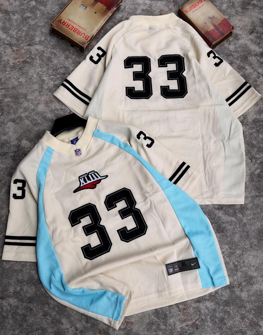 Two number 33 mesh jerseys in cream with light blue accents showing front and back views.