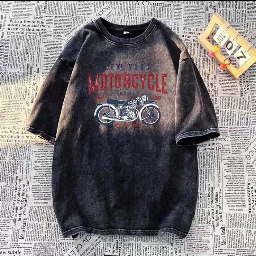 Dark washed t-shirt with New York Motorcycle Society graphic, laid flat on newspaper.