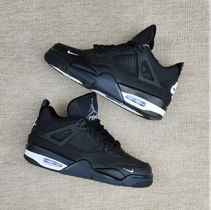 Nike Air Jordan 4 Black Cat sneakers shown from multiple angles on a textured surface.