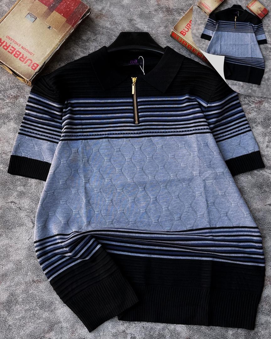 Black and light blue striped diamond knit quarter-zip sweater with gold zipper and textured knit body.