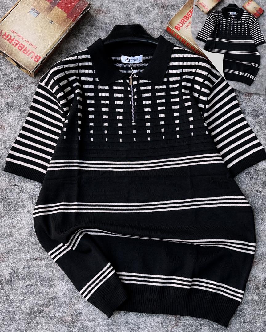 Black and white striped grid knit quarter-zip sweater on black hanger with striped sleeves.