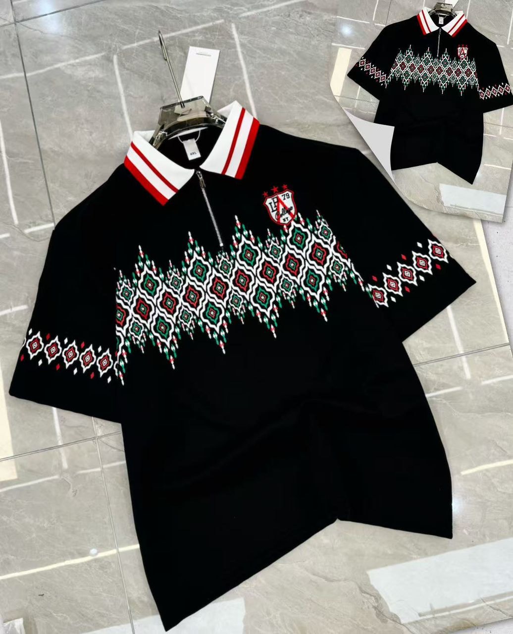 Black geometric print quarter-zip polo shirt with white and red collar accents and logo.