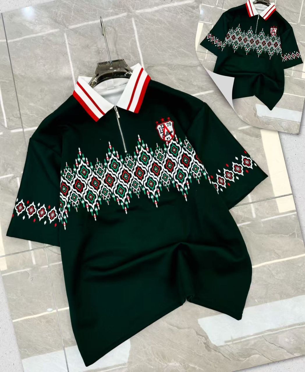 Dark green geometric print quarter-zip polo shirt displayed with detailed sleeve and chest design.