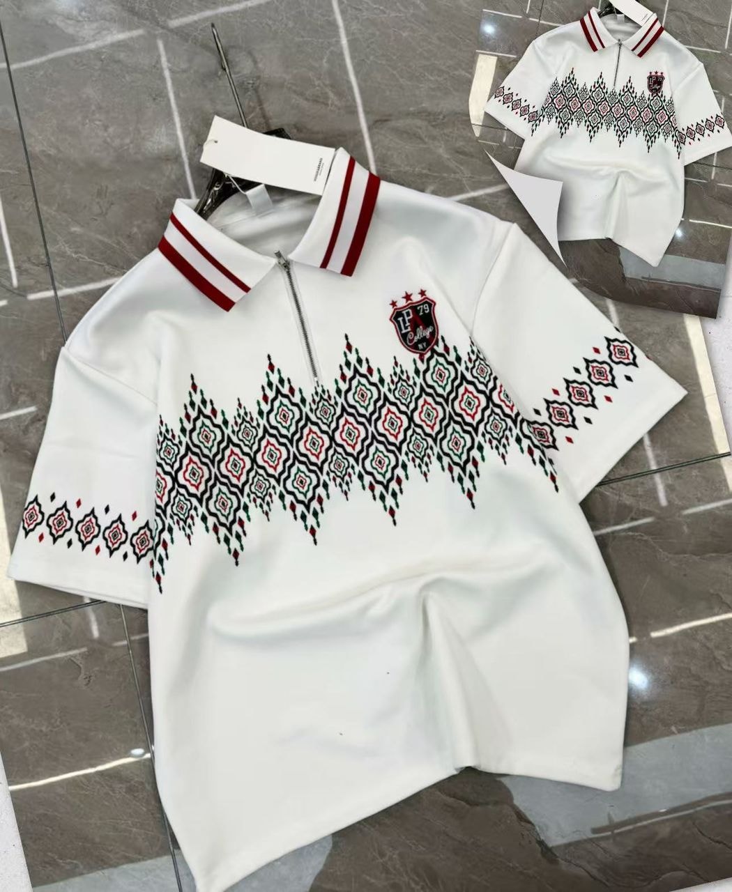 White geometric print quarter-zip polo shirt showing intricate pattern and red striped collar.