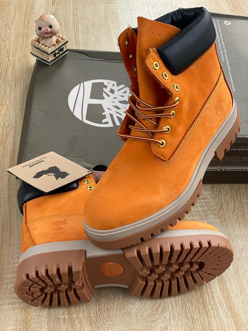 Orange suede Timberland 6-inch boot with black collar and box.