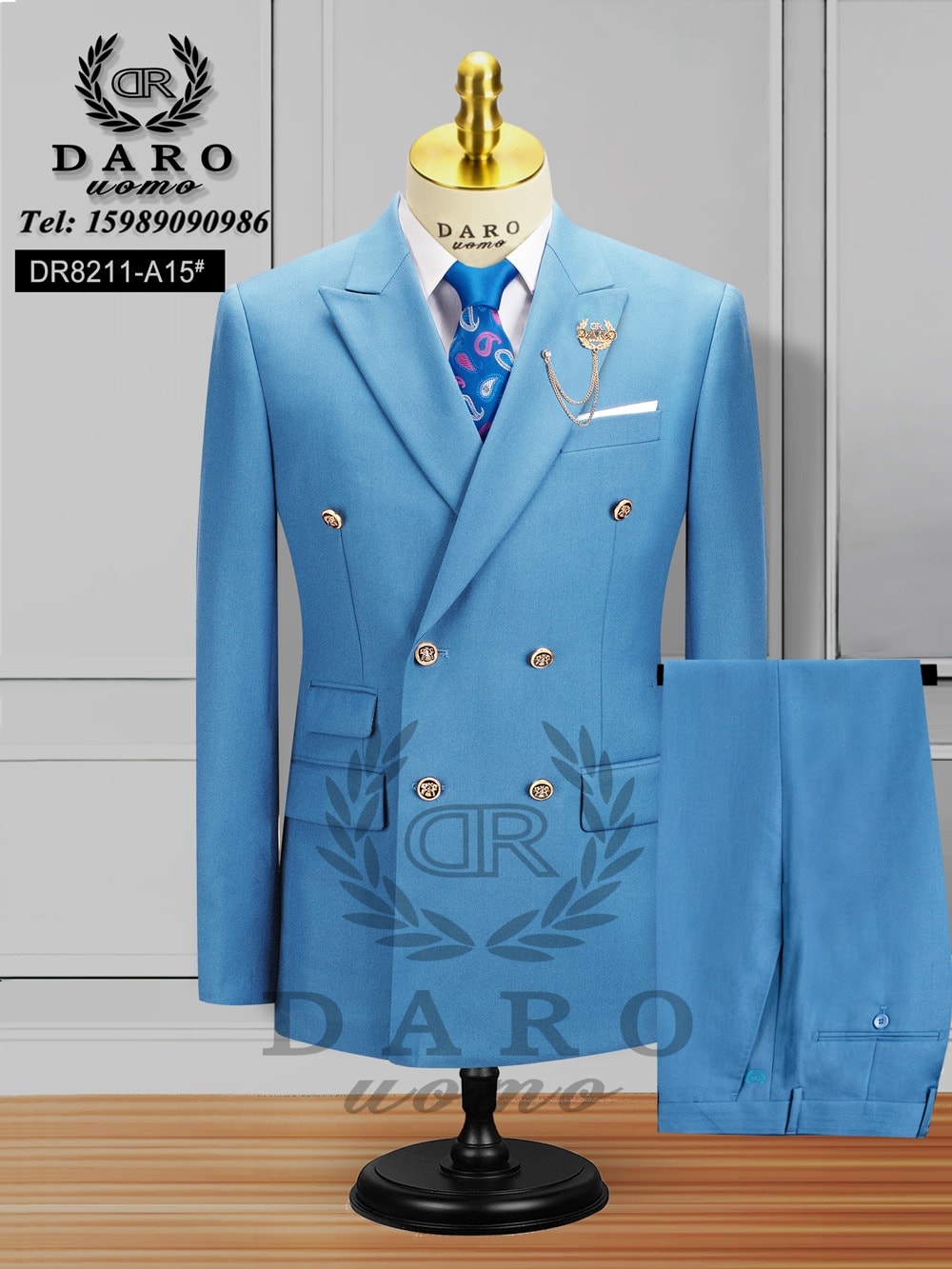 Light blue double breasted Daro suit with white shirt, blue tie and trousers on mannequin.