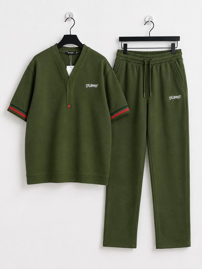Olive green short sleeve V-neck top and jogger pants hanging on black hangers against white background.