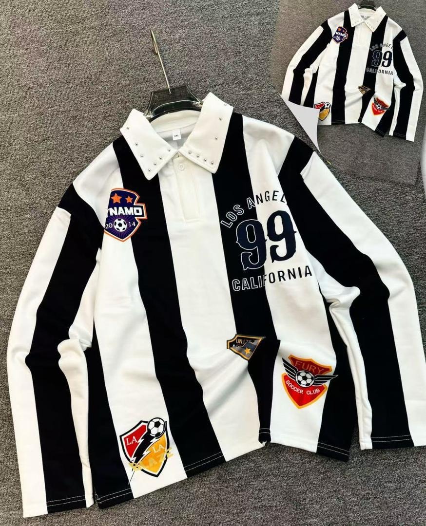 Black and white striped long-sleeve polo shirt with soccer patches and studded collar.