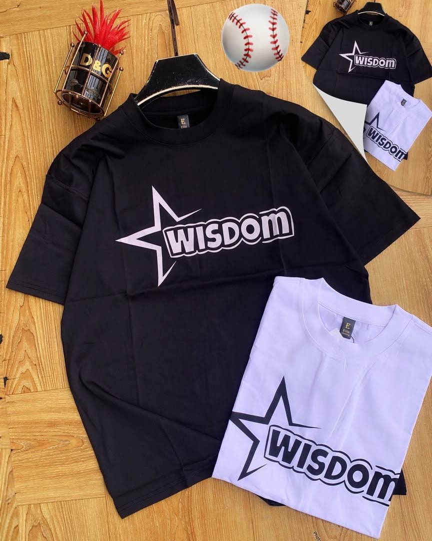 Black and white Wisdom star t-shirts on wooden surface.