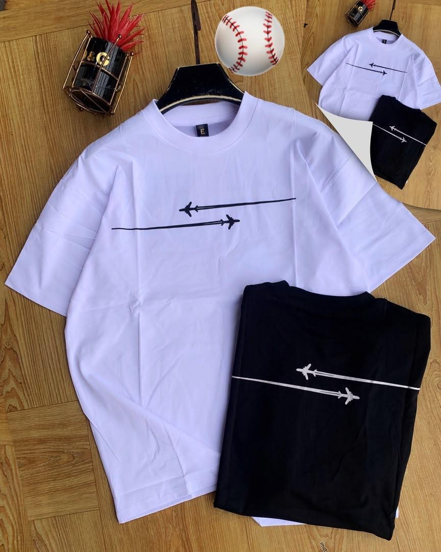 White and black airplane trail t-shirts displayed with props.