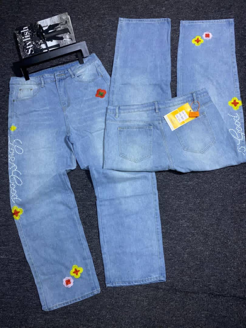 Light blue jeans with colorful flower patches, beadwork and multiple views including back.