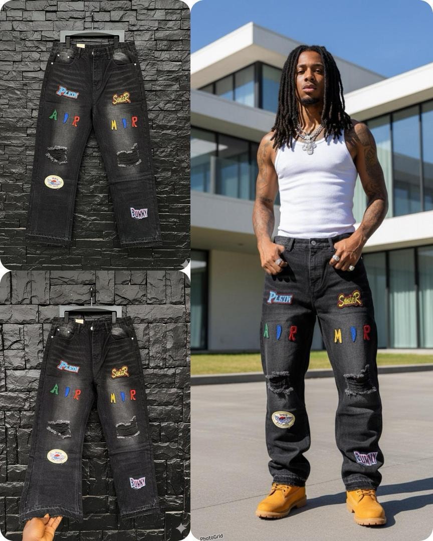 Black baggy jeans with colorful patches, graphics and rips shown in multiple views.
