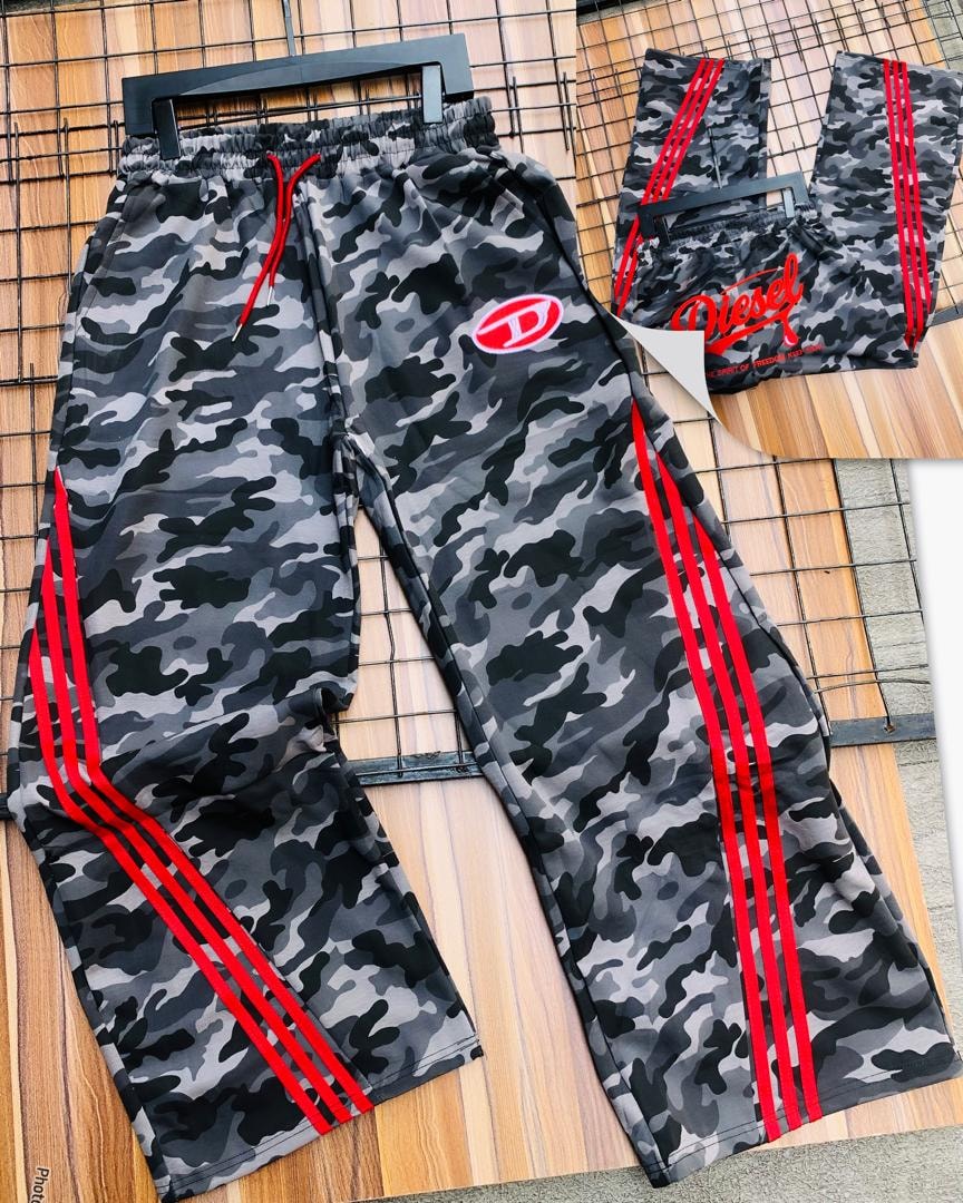 Diesel gray camo joggers full view with red drawcord and side stripes on wooden background.