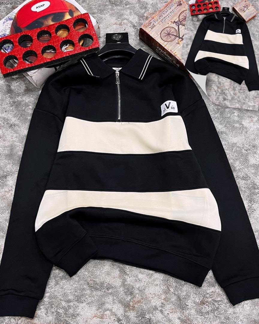 Black striped quarter-zip long sleeve collar top laid flat with accessories.
