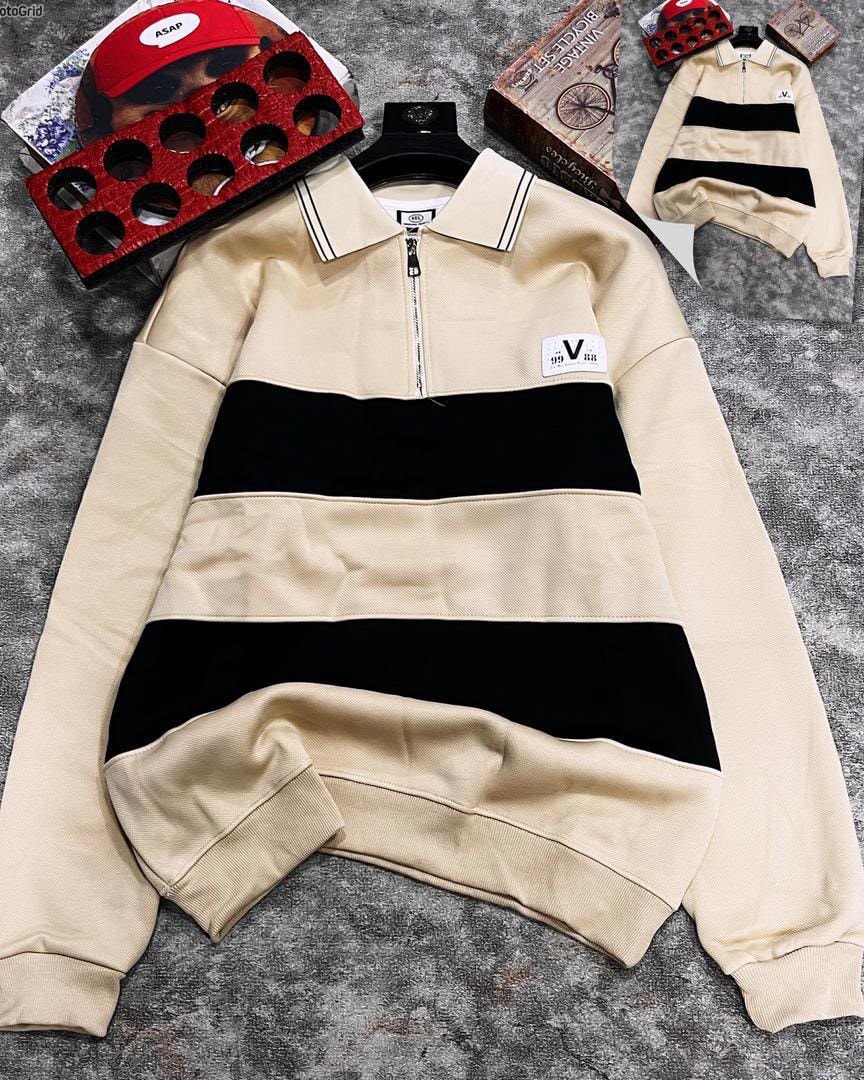 Cream striped quarter-zip long sleeve collar top laid flat with accessories.