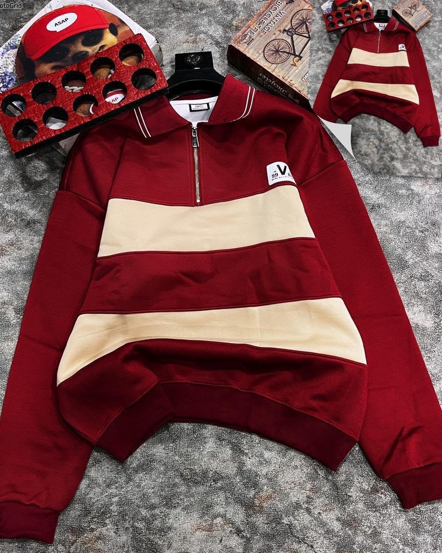 Burgundy striped quarter-zip long sleeve collar top laid flat with accessories.