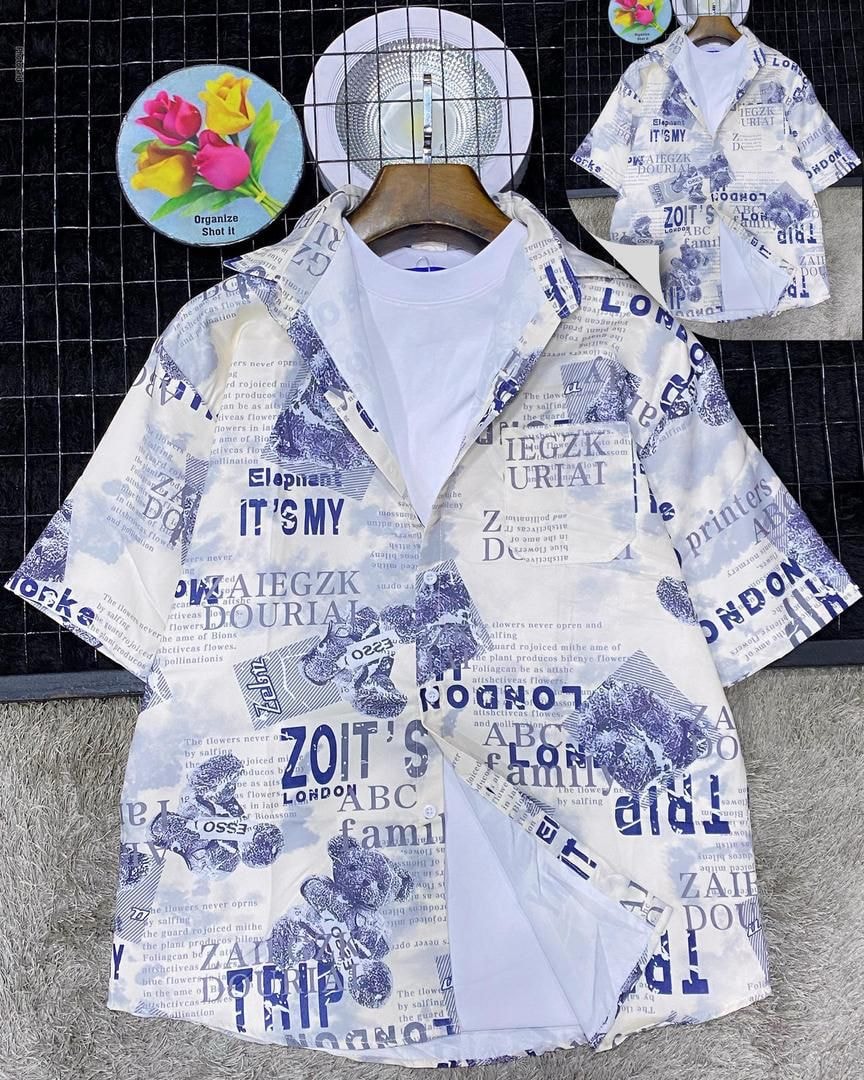 White short sleeve shirt with blue newspaper text and illustration print on grid with hat and tulips.