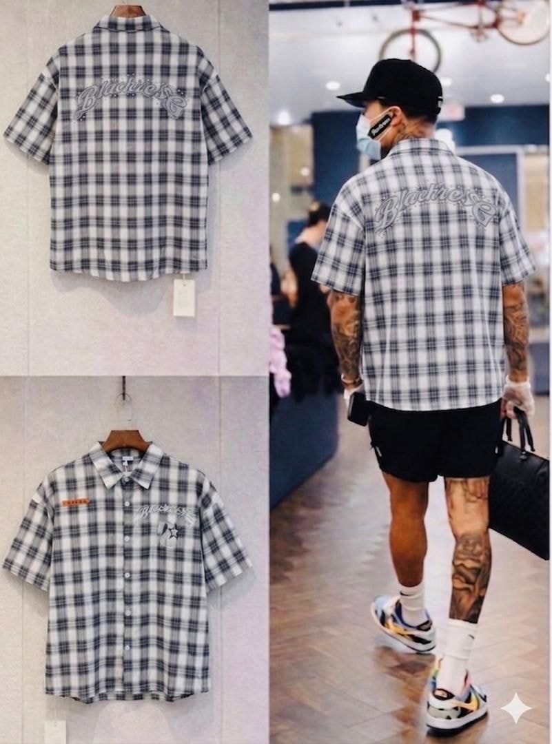 Black plaid embroidered short sleeve shirt displayed on hanger from multiple angles and worn by model.