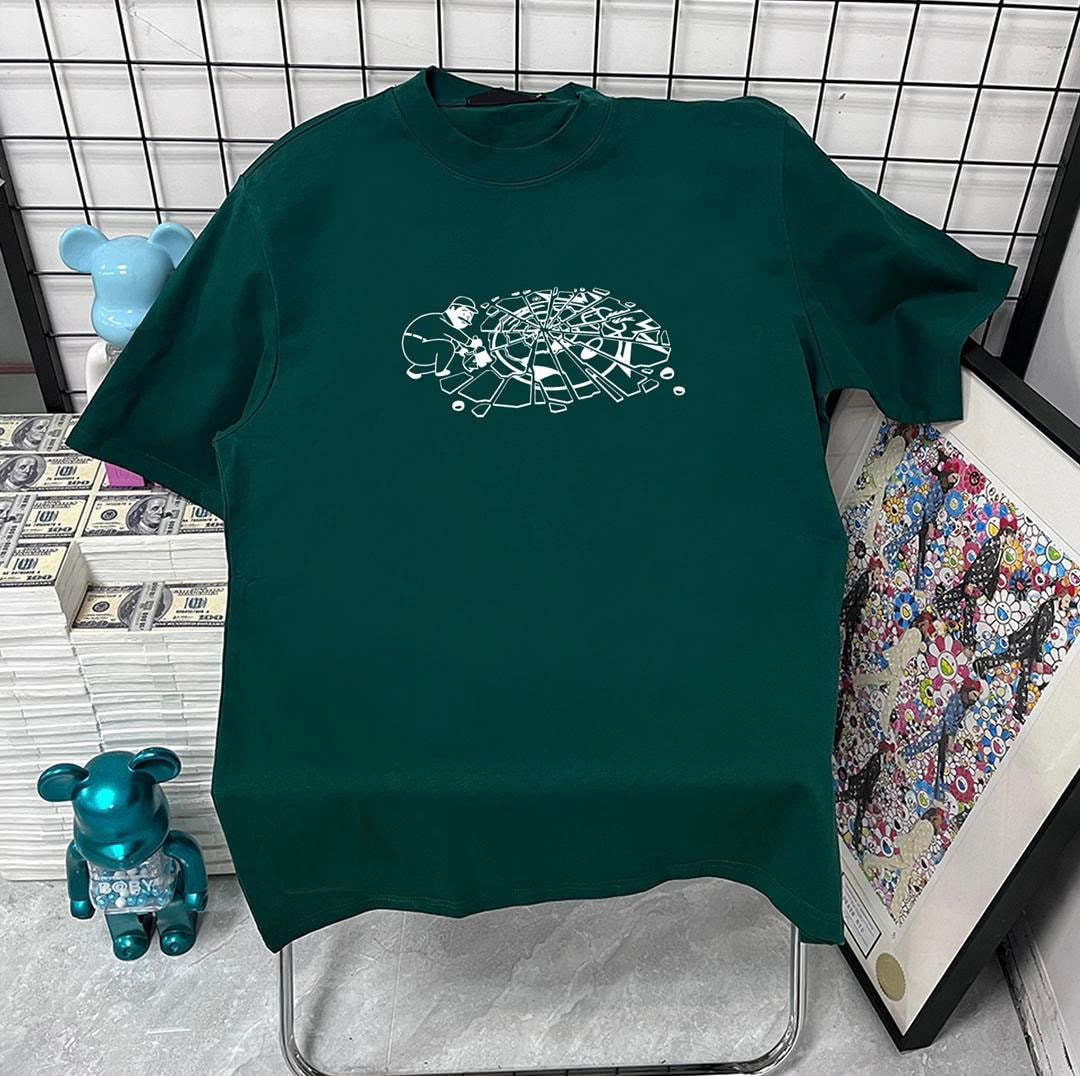 Green t-shirt with white shattered wheel graphic on chest.