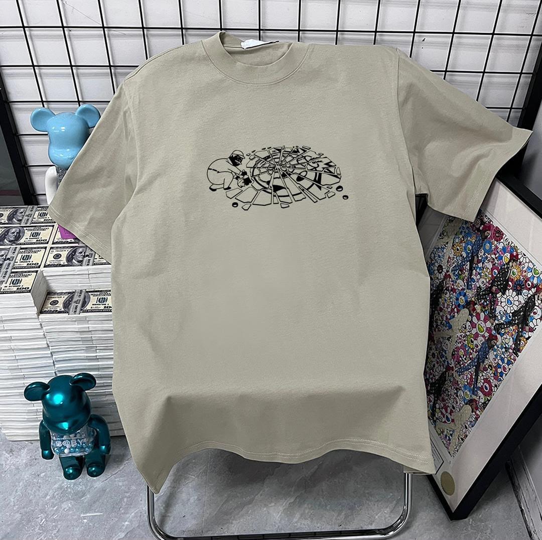 Beige t-shirt with black shattered wheel graphic on chest.