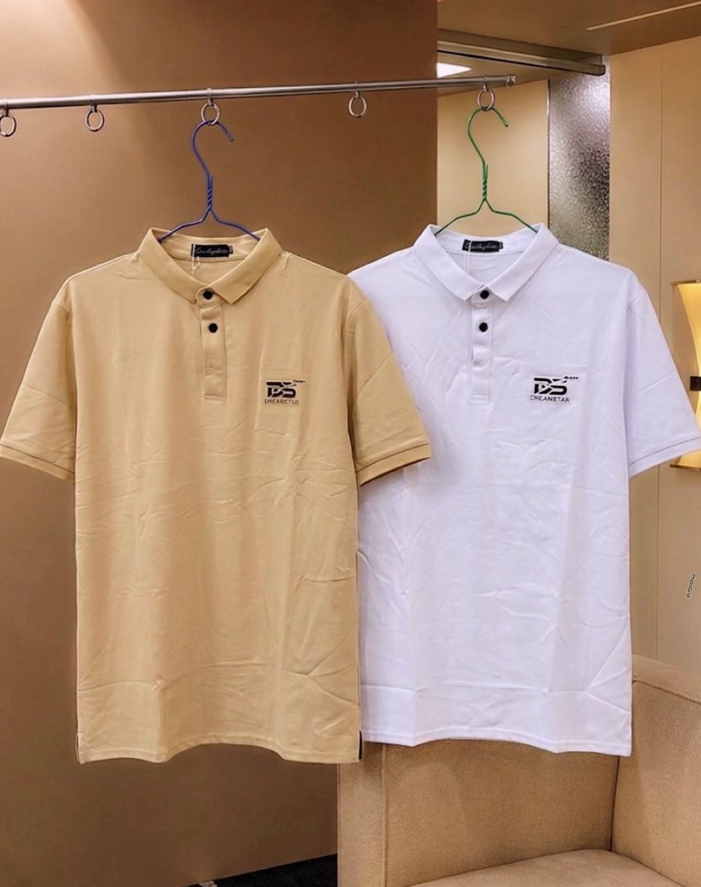 Yellow and white Dream Star polo shirts hanging side by side.