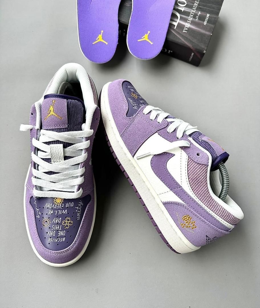 Purple and white Air Jordan 1 Low sneakers with graphic details and purple insoles.