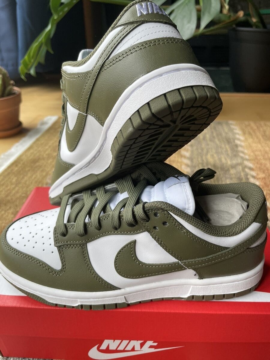 Olive green and white Nike Dunk Low sneakers on red Nike box.