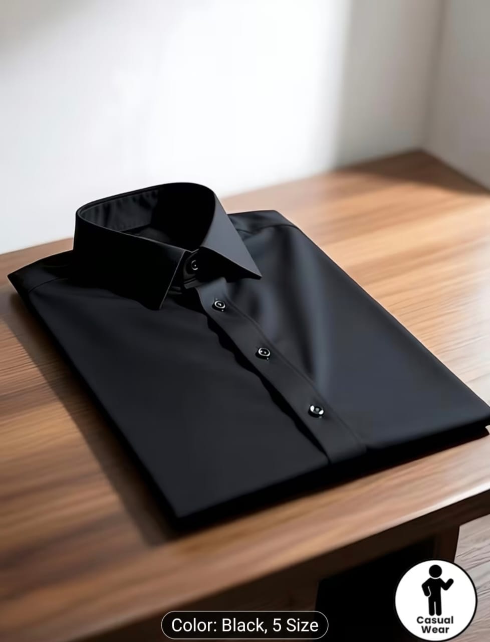 Black long sleeve dress shirt on wooden table with casual wear logo.