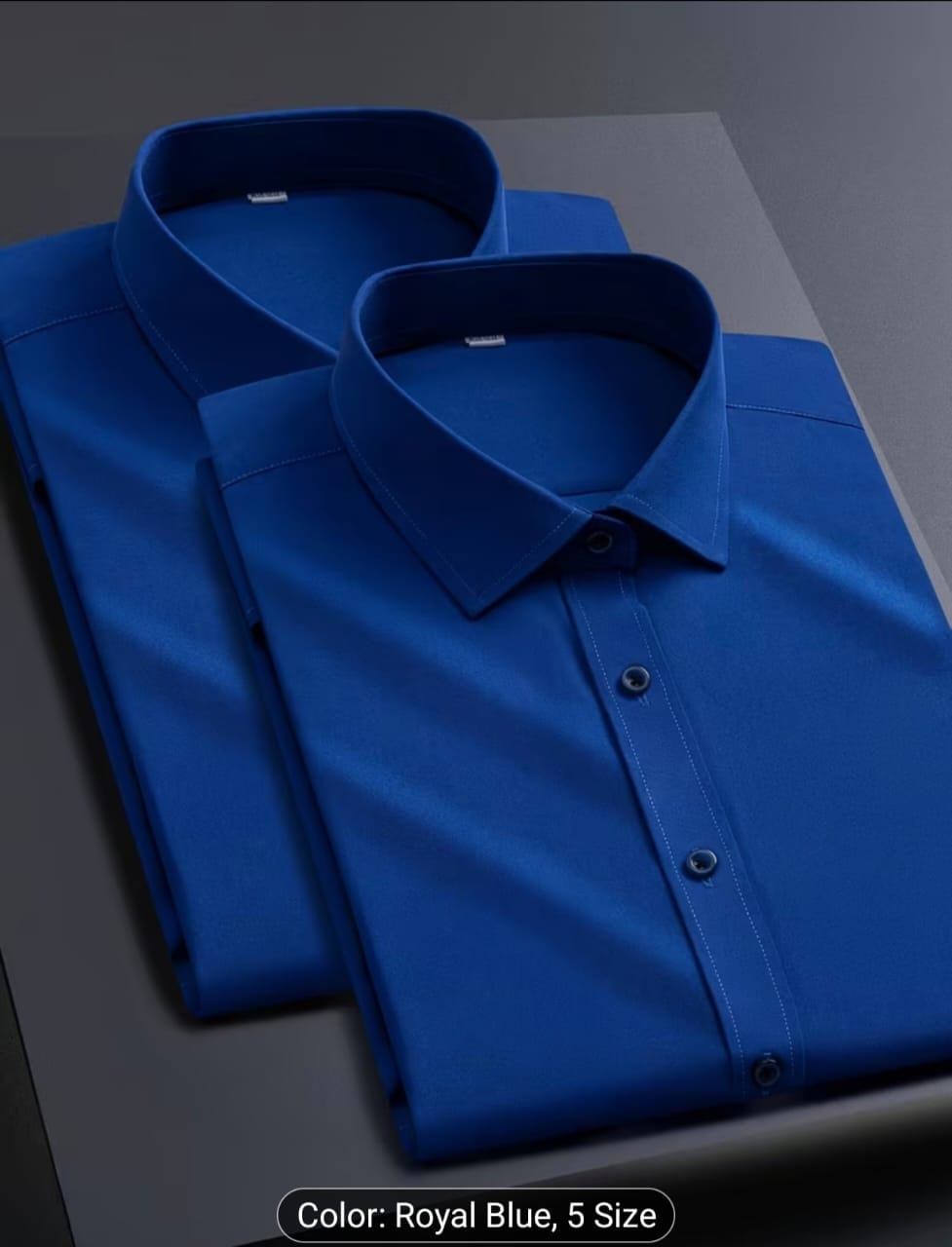 Royal blue long sleeve dress shirt folded on surface.