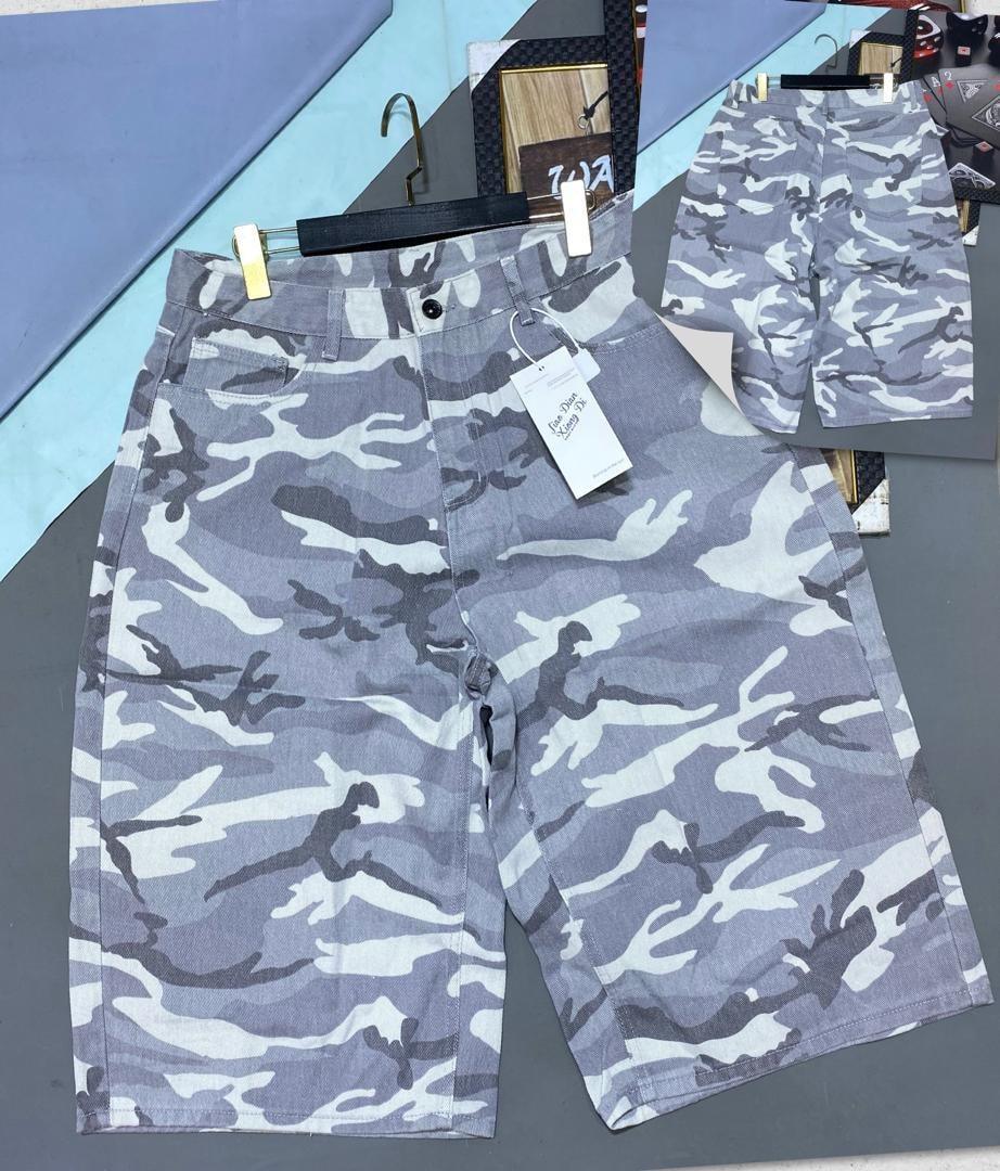 Gray camouflage cargo 3/4 shorts featuring cargo pockets and front button closure.
