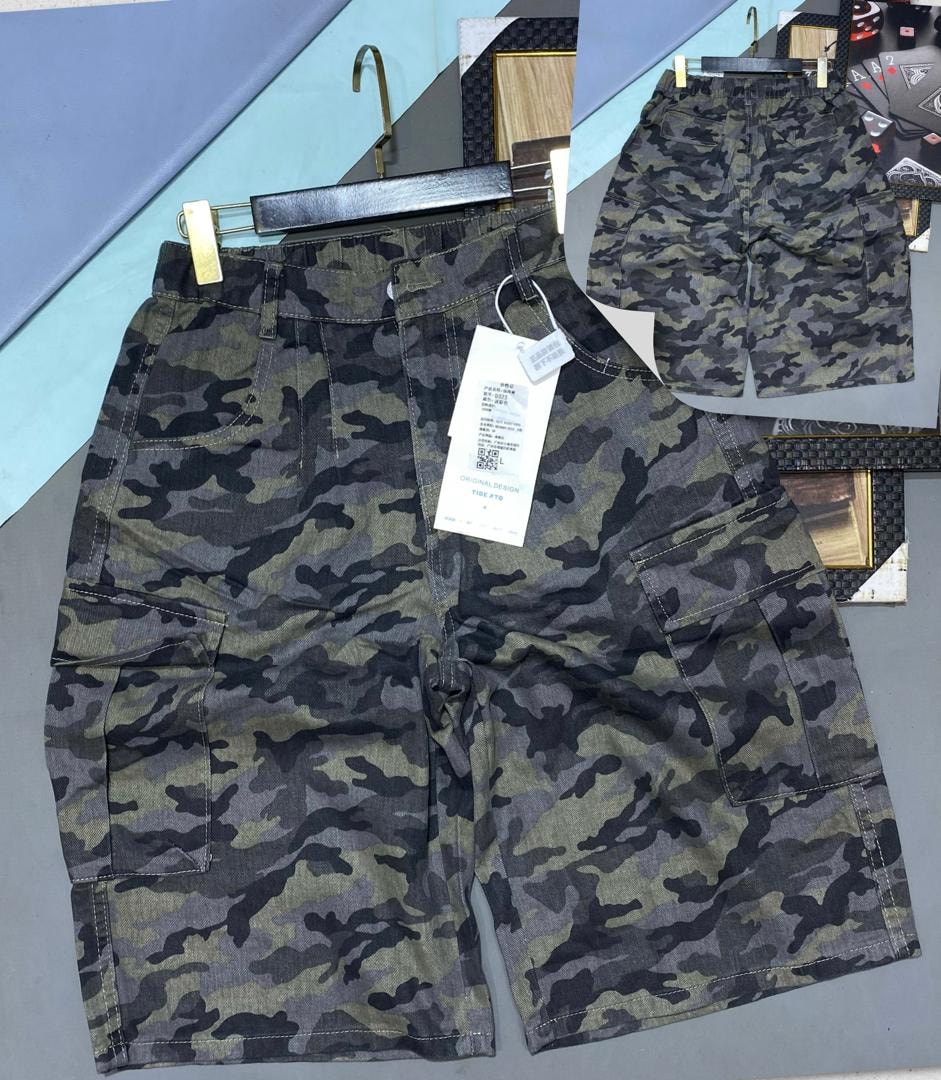 Olive camouflage cargo 3/4 shorts with large thigh pockets shown on hanger.