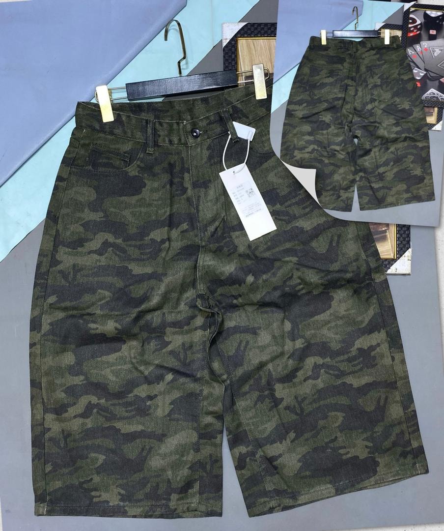 Green camouflage 3/4 shorts displayed on hanger showing front and back views.