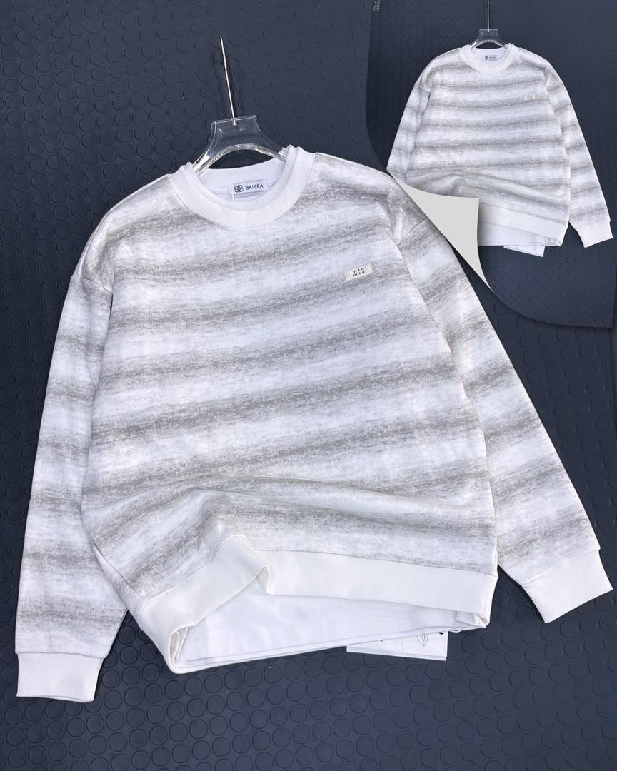 Gray and white horizontally striped long sleeve sweatshirt with small chest label, front view.
