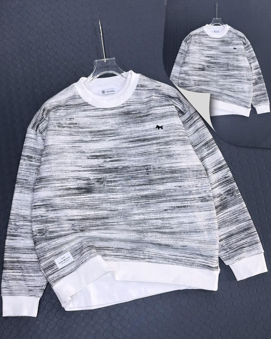 Marbled black and white long sleeve sweatshirt with small black logo on chest, front view on hanger.
