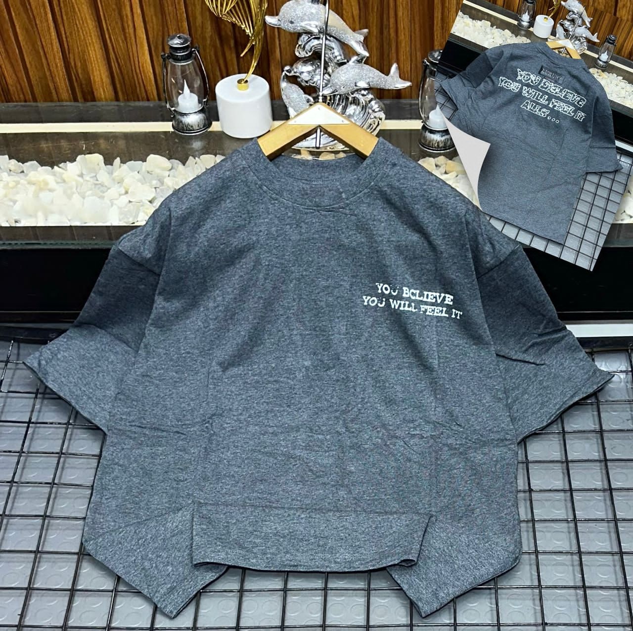 Gray oversized t-shirt with YOU BELIEVE YOU WILL FEEL IT text on chest and back inset.