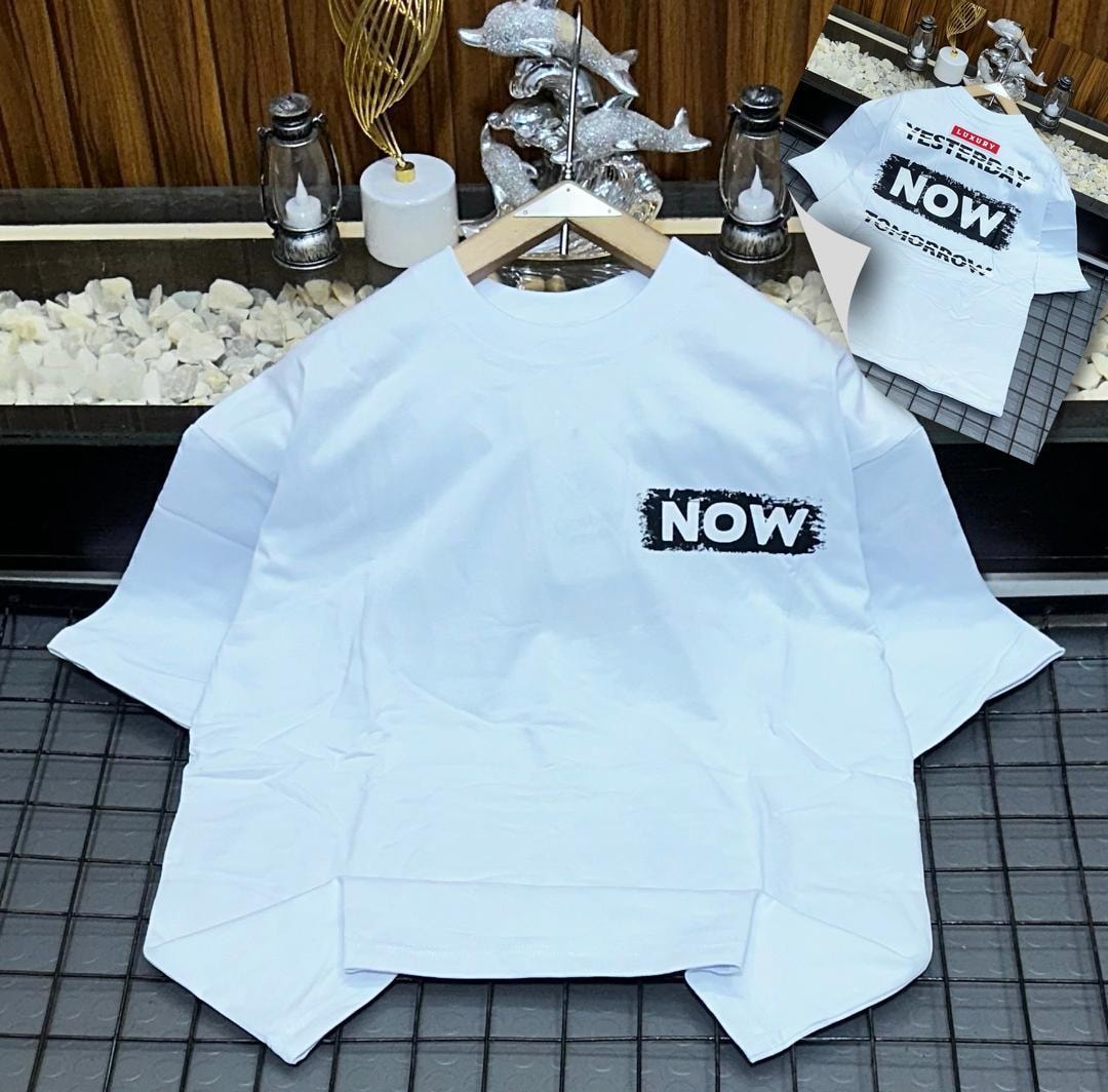 White oversized t-shirt with NOW brush stroke print on chest and back text inset.