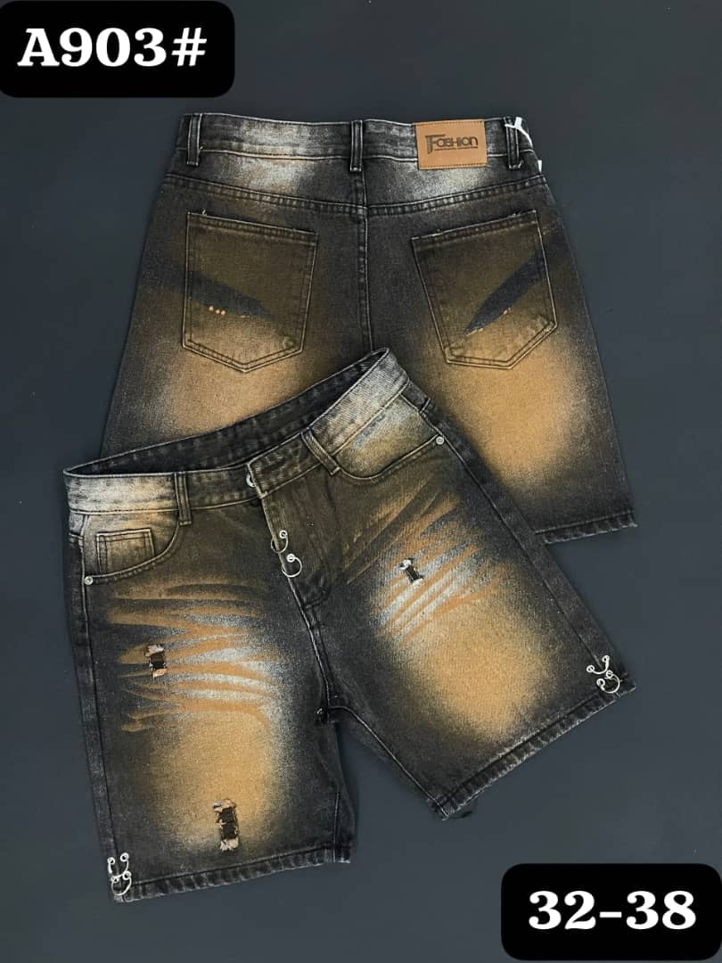 Front and back views of dark denim jorts with spray paint effects, rips and raw hems.