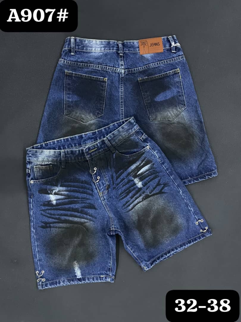 Front and back views of blue distressed denim jorts with scratched patterns and side rings.