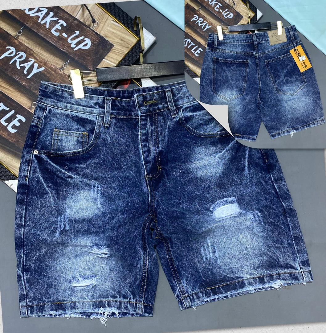 Front and back views of light blue ripped denim jorts with faded effects and raw edges.