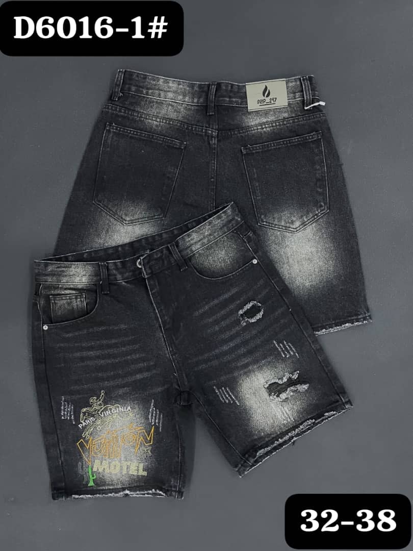 Front and back views of black graphic distressed denim jorts with text print and rips.