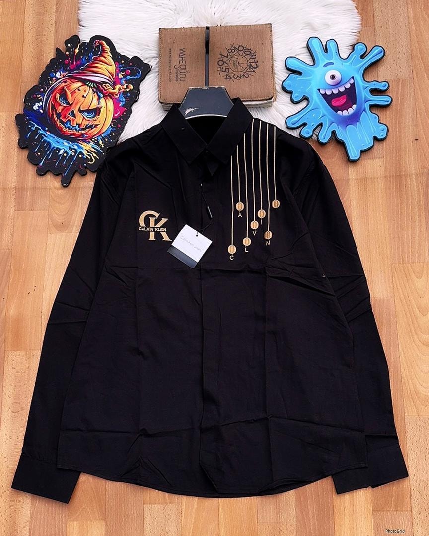 Black Calvin Klein shirt with gold chain medallions and chest logo.