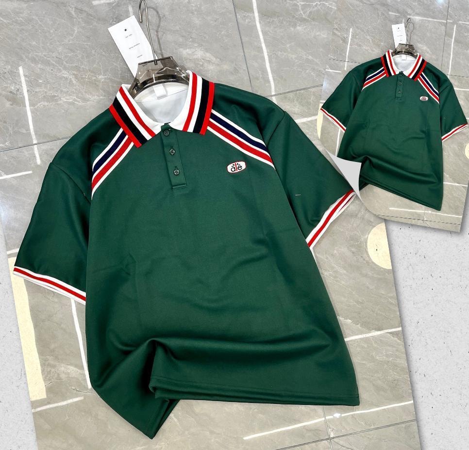 Green polo shirt with striped collar trim and dié chest logo.