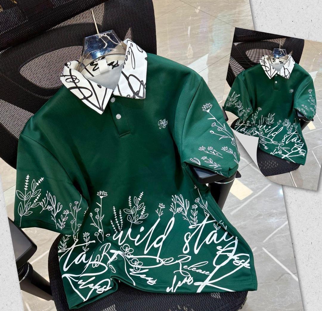 Green printed polo shirt with white floral script designs and patterned collar.