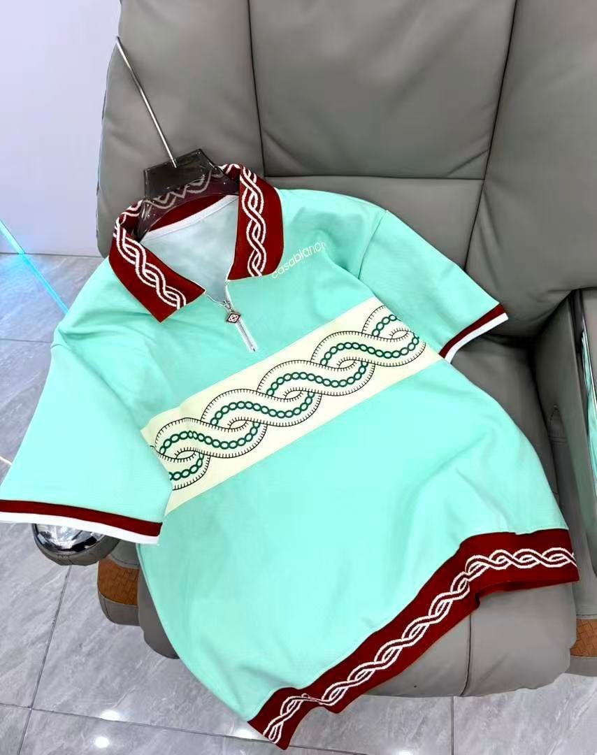 Turquoise Casablanca polo shirt with red trim and green chain embroidery.
