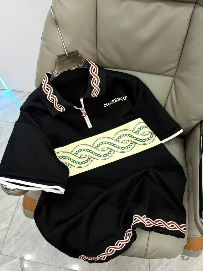 Black Casablanca polo shirt with white and red trim and green chain embroidery.